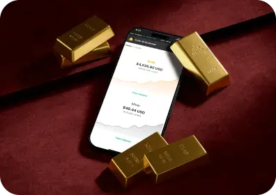 A smartphone displaying charts of gold and silver prices.
