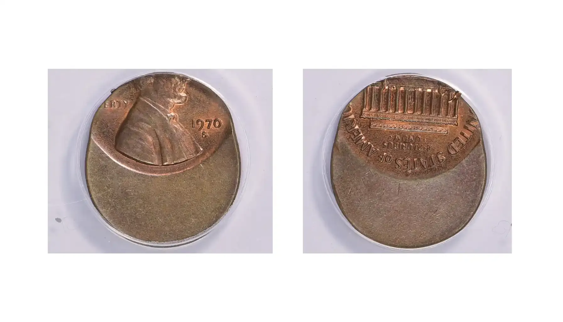 A picture of a 1970-S Lincoln Cent large date struck 60% off-center at 12:00, with most of the design missing and a large blank area on one side of the coin.