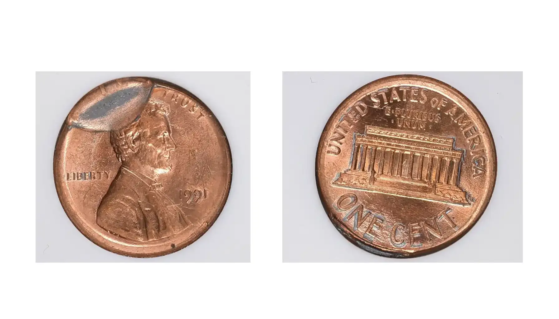 A picture of a 1991 Lincoln Cent with a broadstruck part brockage, displaying an expanded and misshapen design with a partial overlapping image.